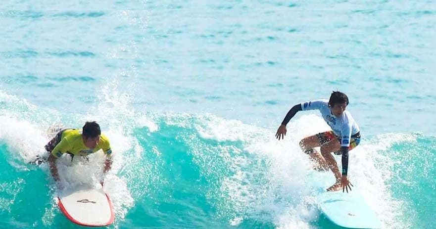 Two surfers catching turquoise waves off Newcastle coastline