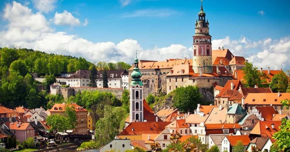 Cesky Krumlov castle and red rooftops in sunny panorama