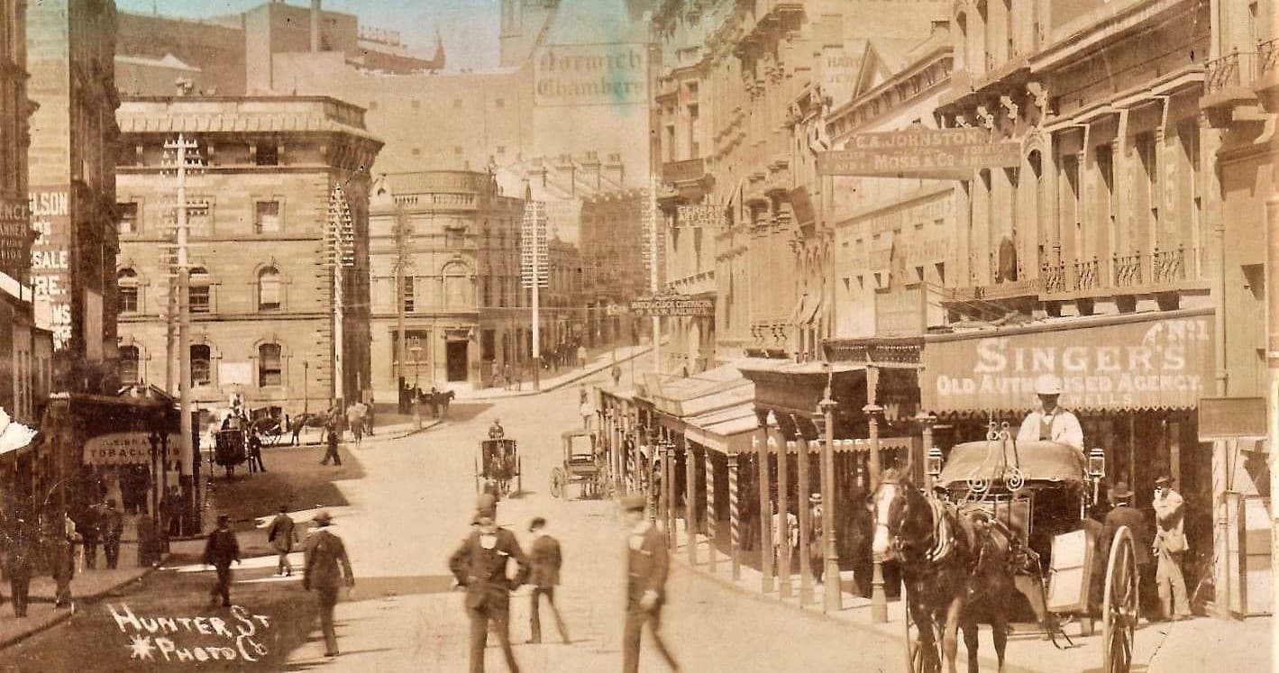 Historic Victorian street with horse-drawn carriages, city tour