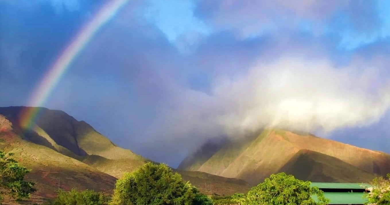 Rainbow over Maui mountains and lush valley scenic vista