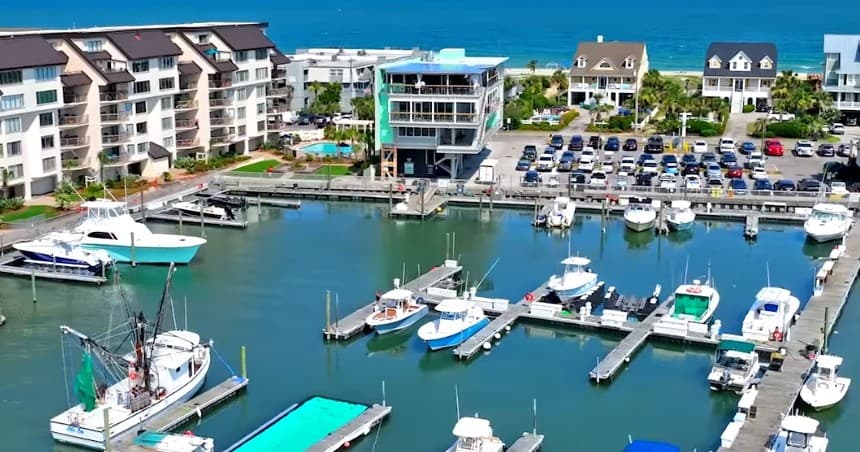 Aerial view of Harbor Marina with boats and waterfront condos
