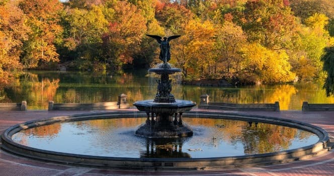 Fountain in Central Park with autumn foliage by lake