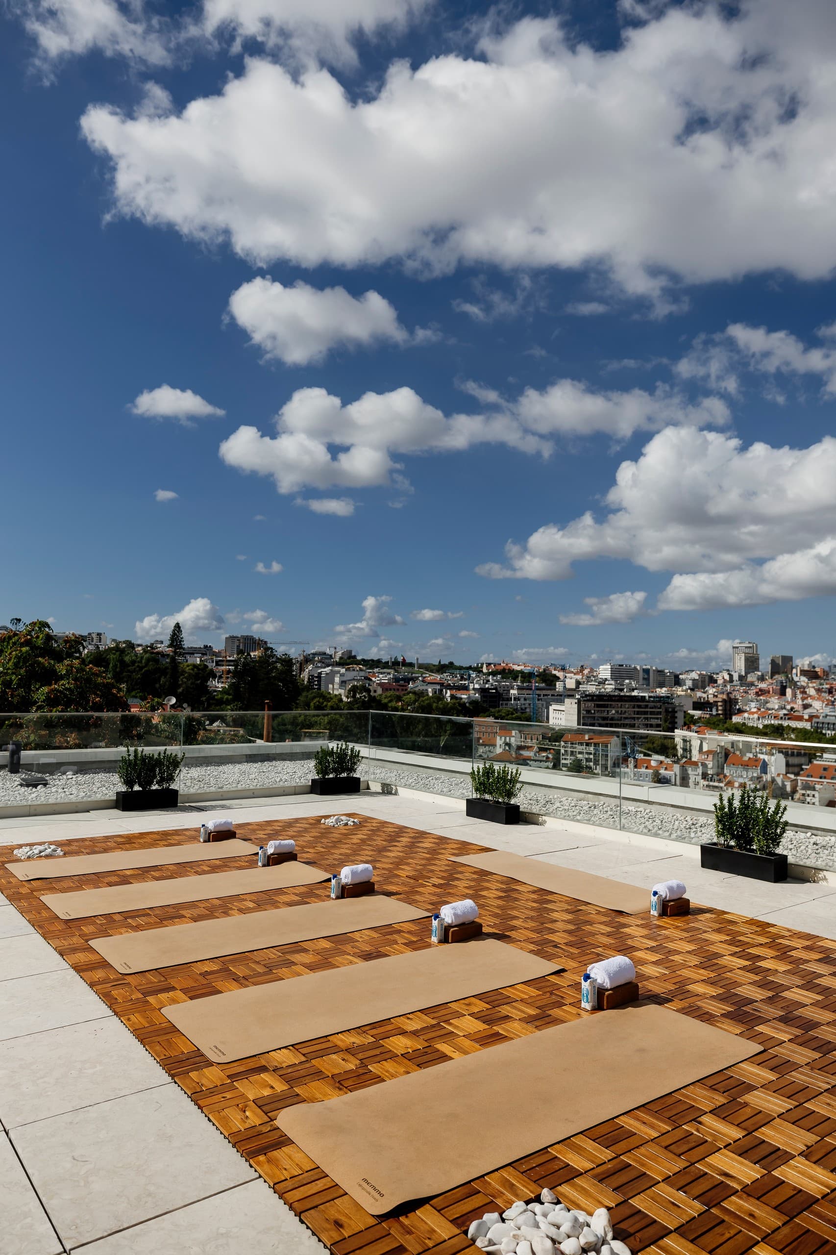 Sunlit rooftop yoga mats and skyline view for group practice