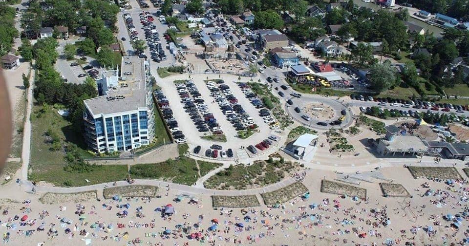 Aerial view of crowded Grand Bend beach and shoreline activities