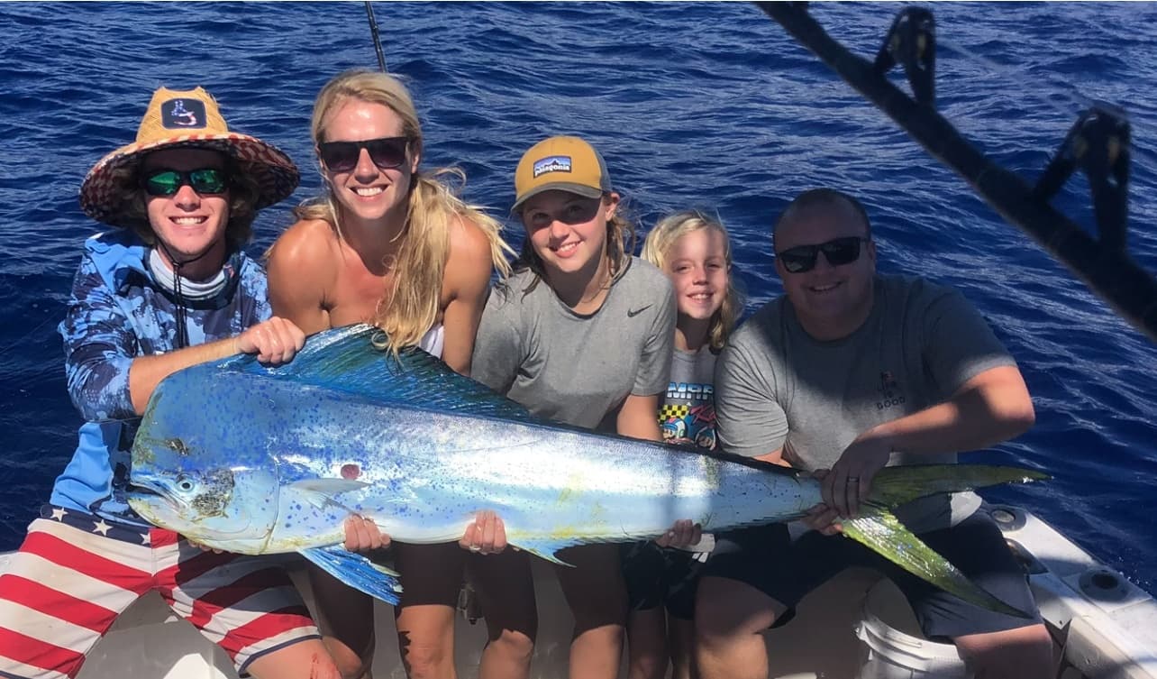 Anglers aboard boat in Kona holding trophy mahi-mahi catch