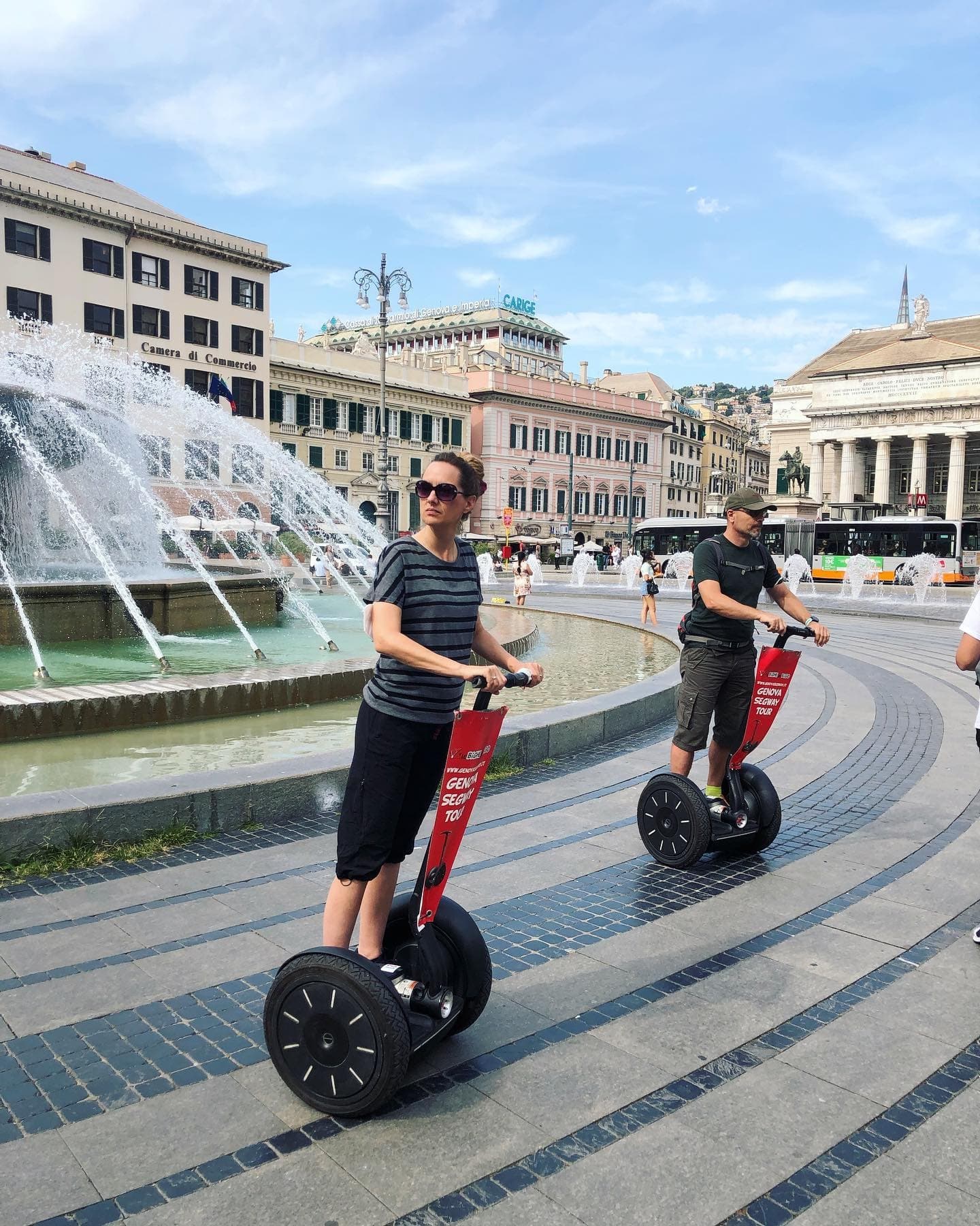 Segway tour riders near fountain in Genoa city square