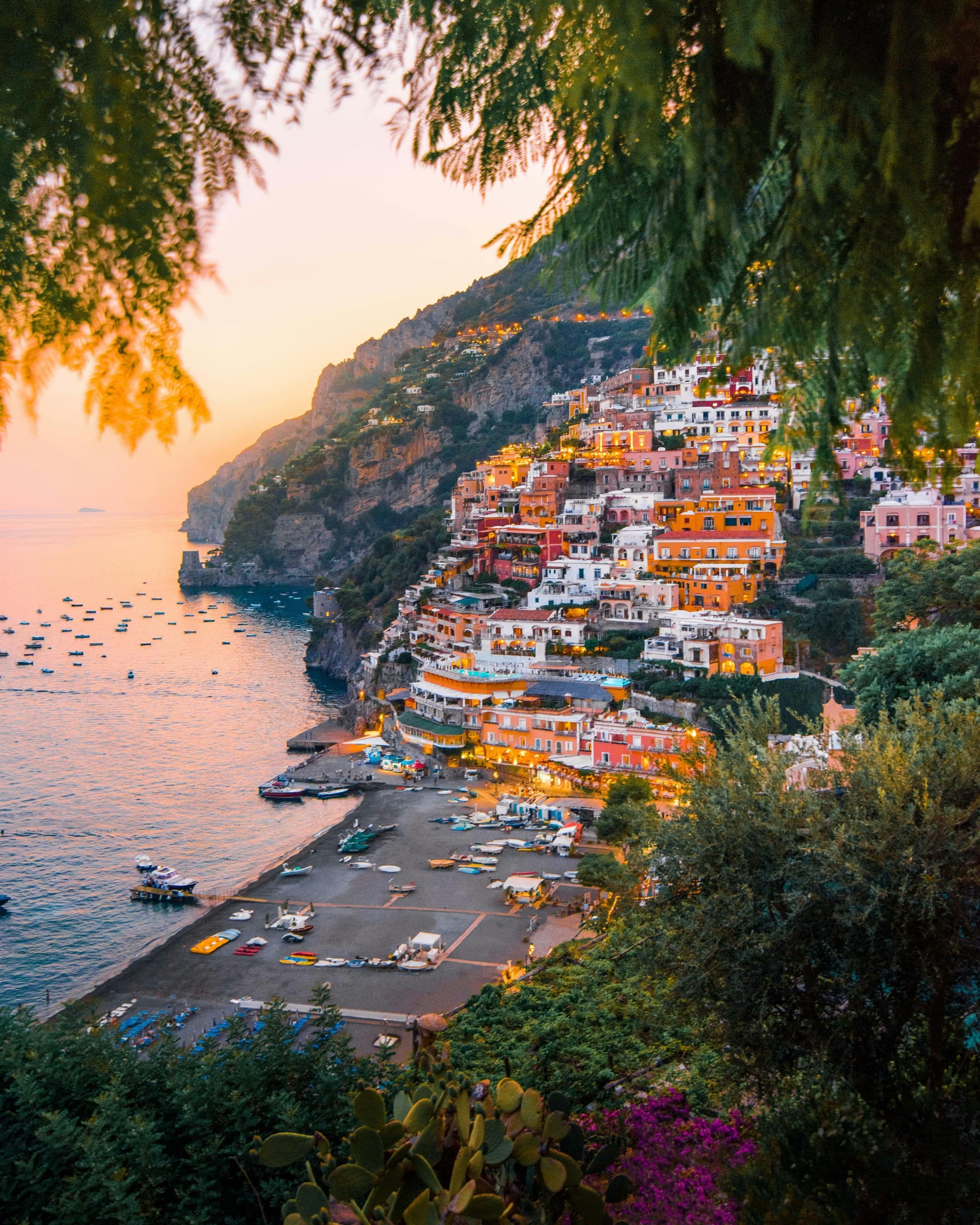Positano village at sunset with coastal cliffs and harbor views