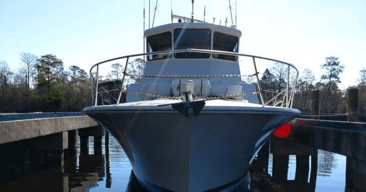 Front view of sportfishing yacht docked in calm marina basin