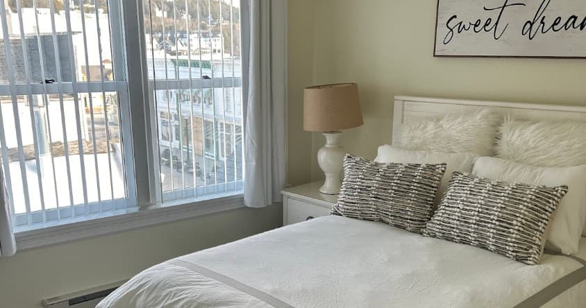 Cozy waterfront bedroom in bright condo overlooking marina, relaxing stay
