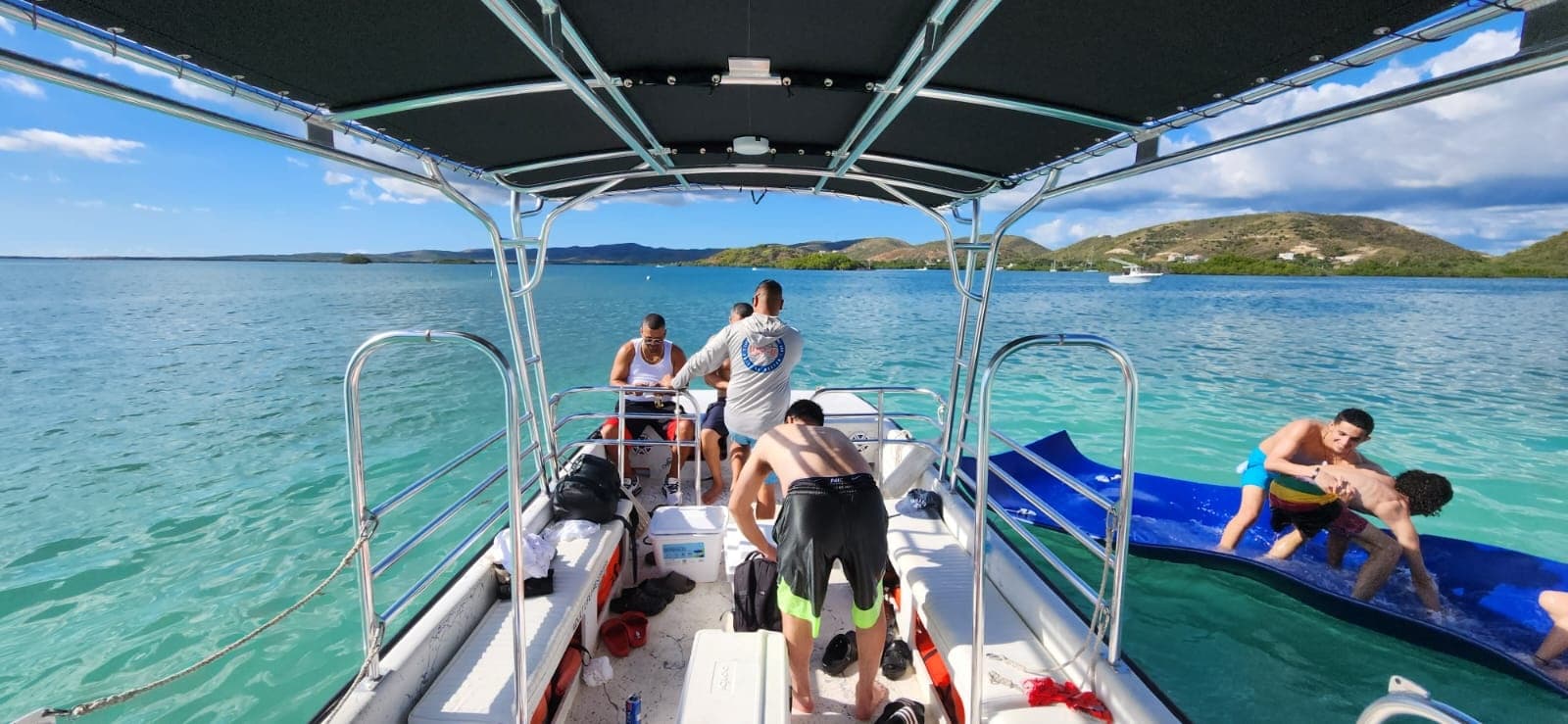 Tour boat deck with passengers cruising crystal waters