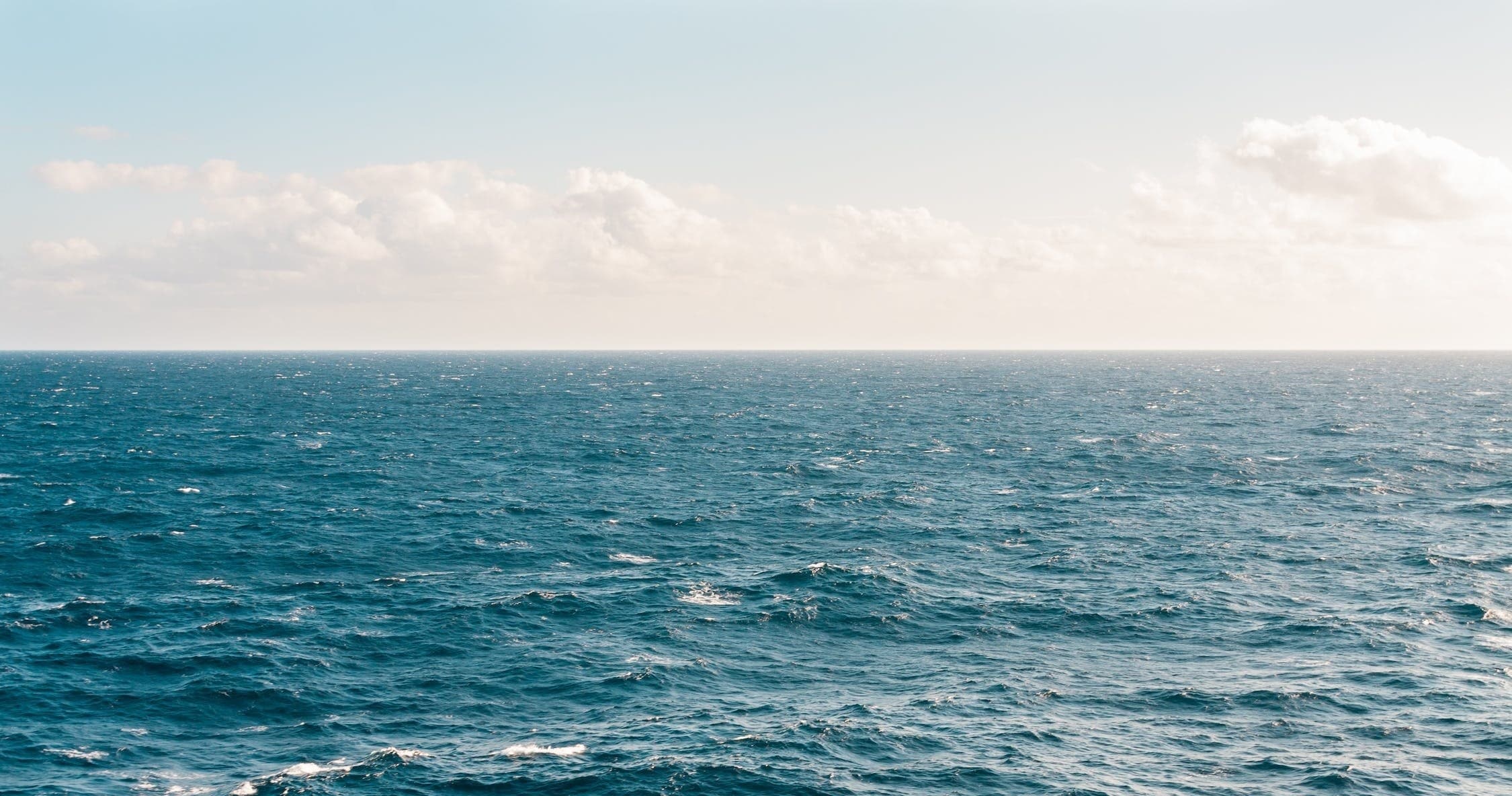 Open ocean horizon with sailing-friendly calm sea
