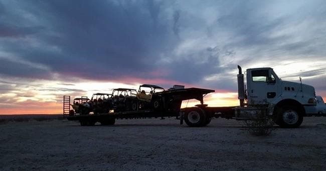 UTV trailers at sunset on desert highway, off-road transport