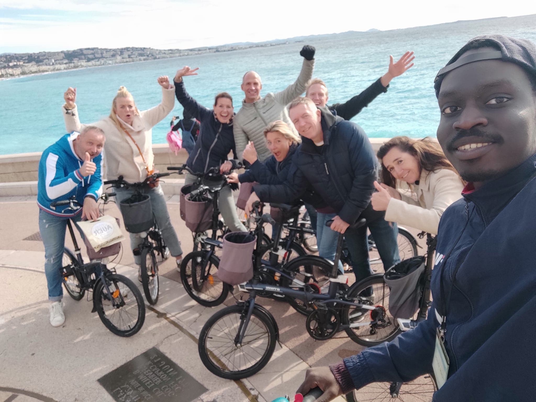 Group on coastal bike tour enjoying seaside city ride