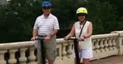 Couple riding Segways on a scenic park bridge near Houston