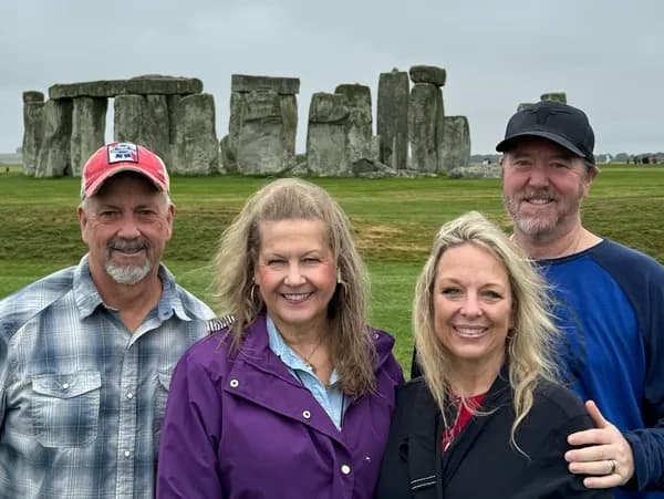 Visitors posing at Stonehenge prehistoric monument tours