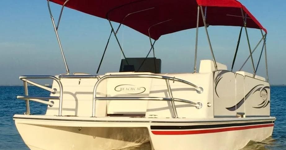 Pontoon boat with canopy cruising calm blue Gulf waters