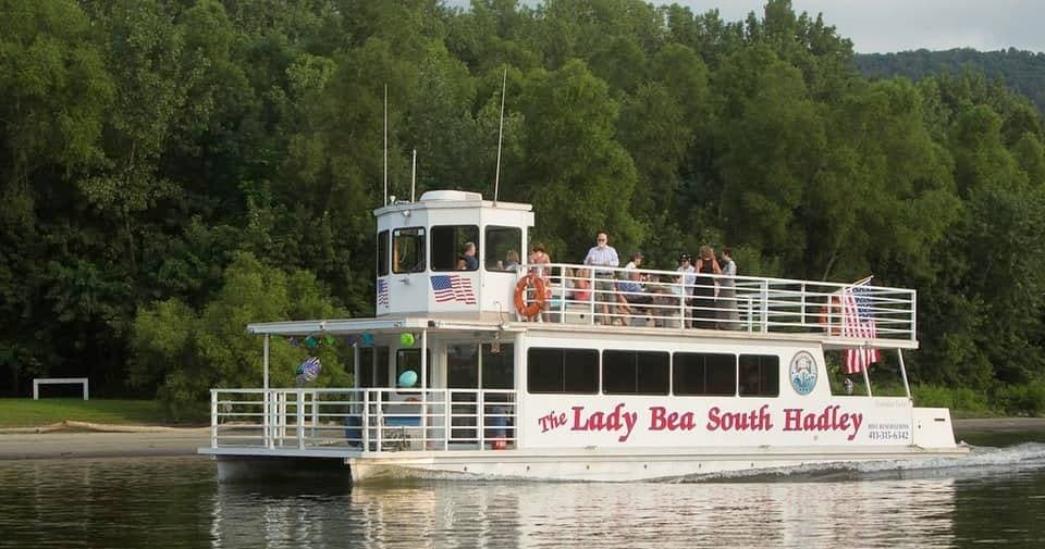 Lady Bea river cruise boat gliding past tree-lined shore