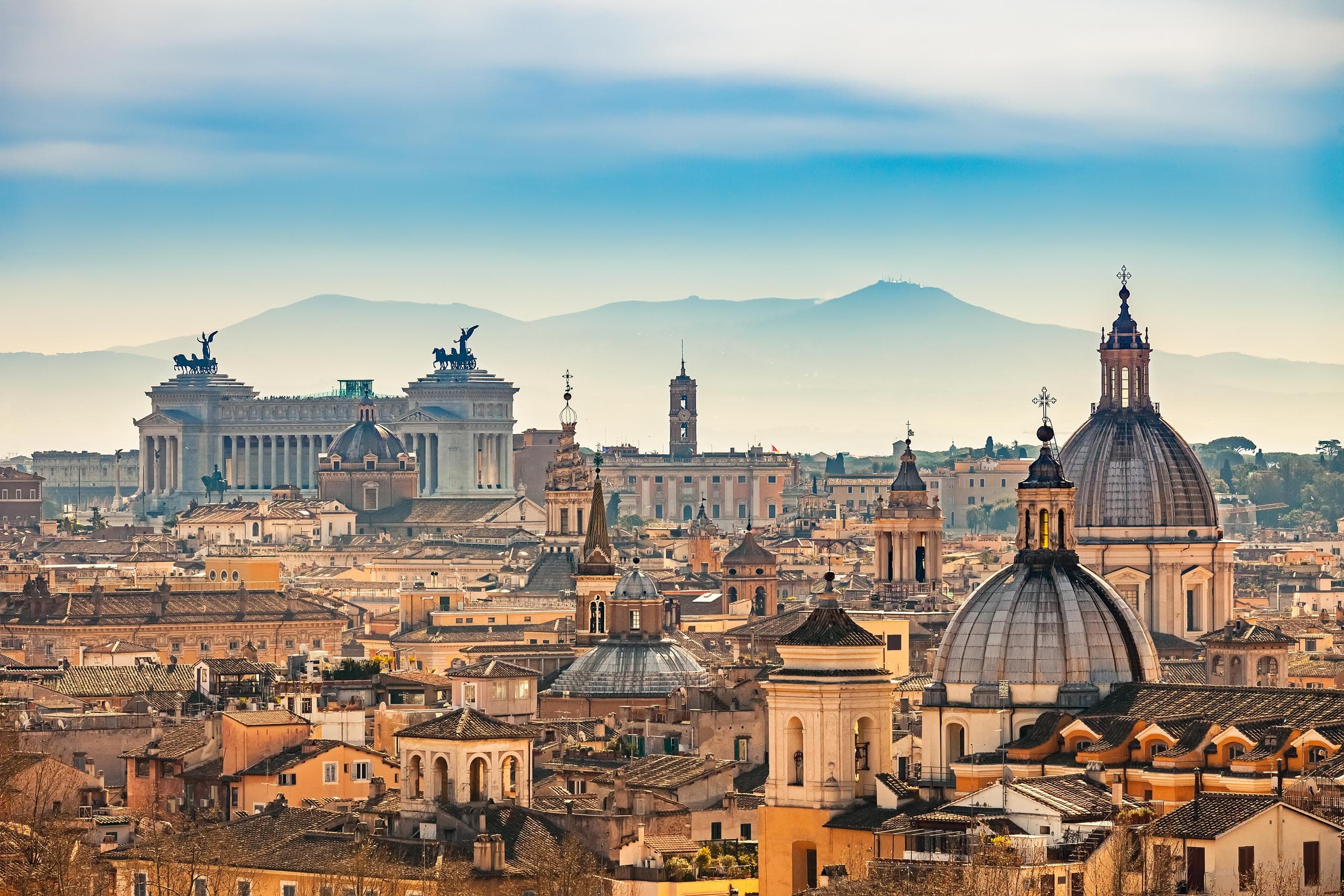 Panoramic Rome skyline with domes and city view at sunset