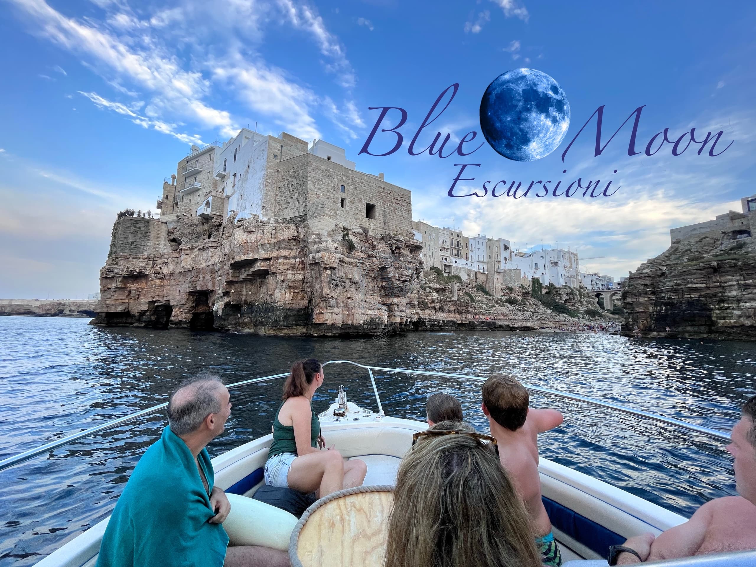 Boat passengers viewing coastal cliffs and seaside town on tour