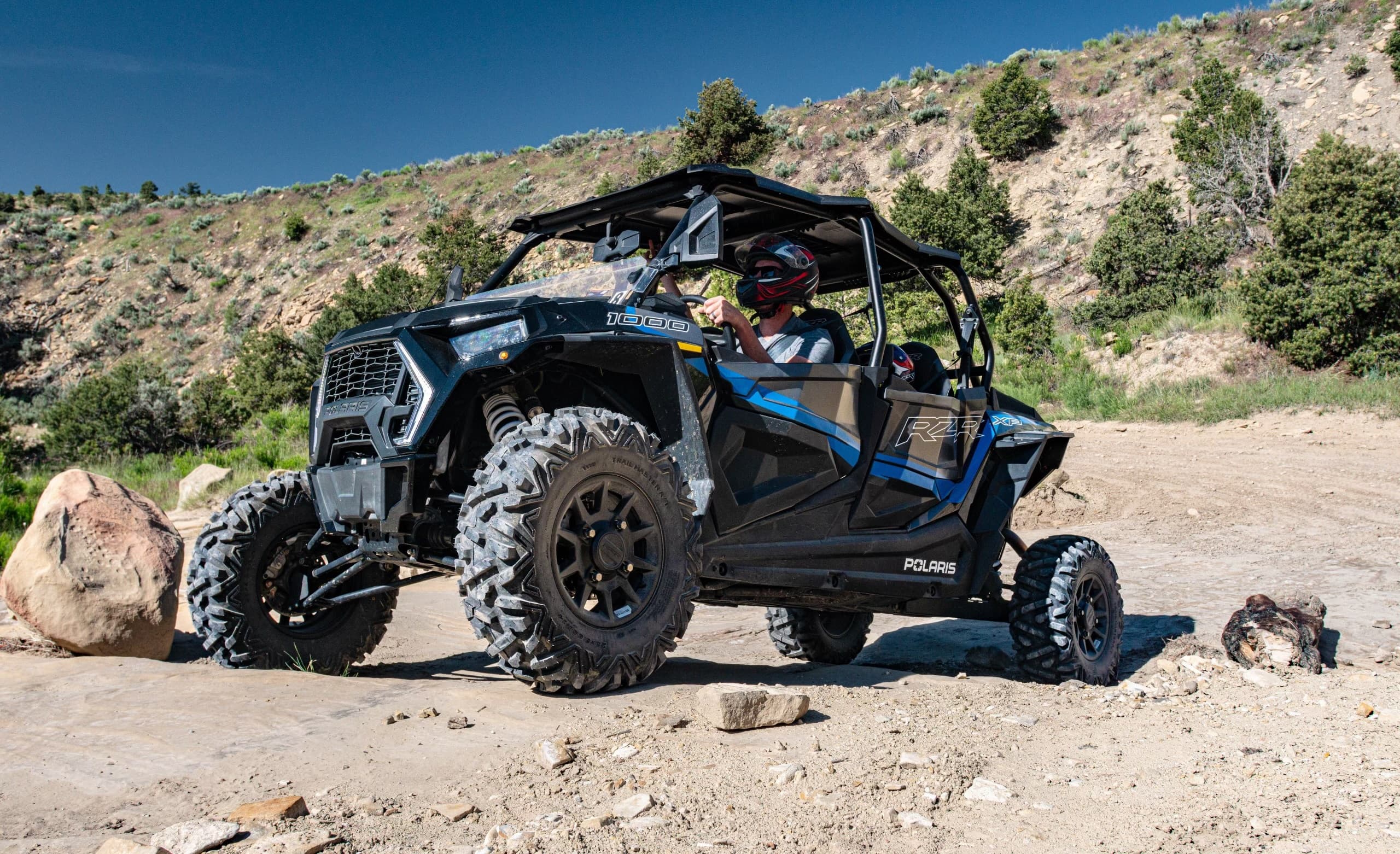 Side-by-side UTV traversing rocky desert terrain for off-road fun