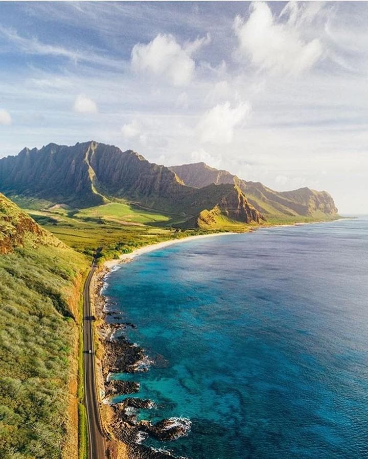 Aerial coastal view of Oahu shoreline and winding mountain road