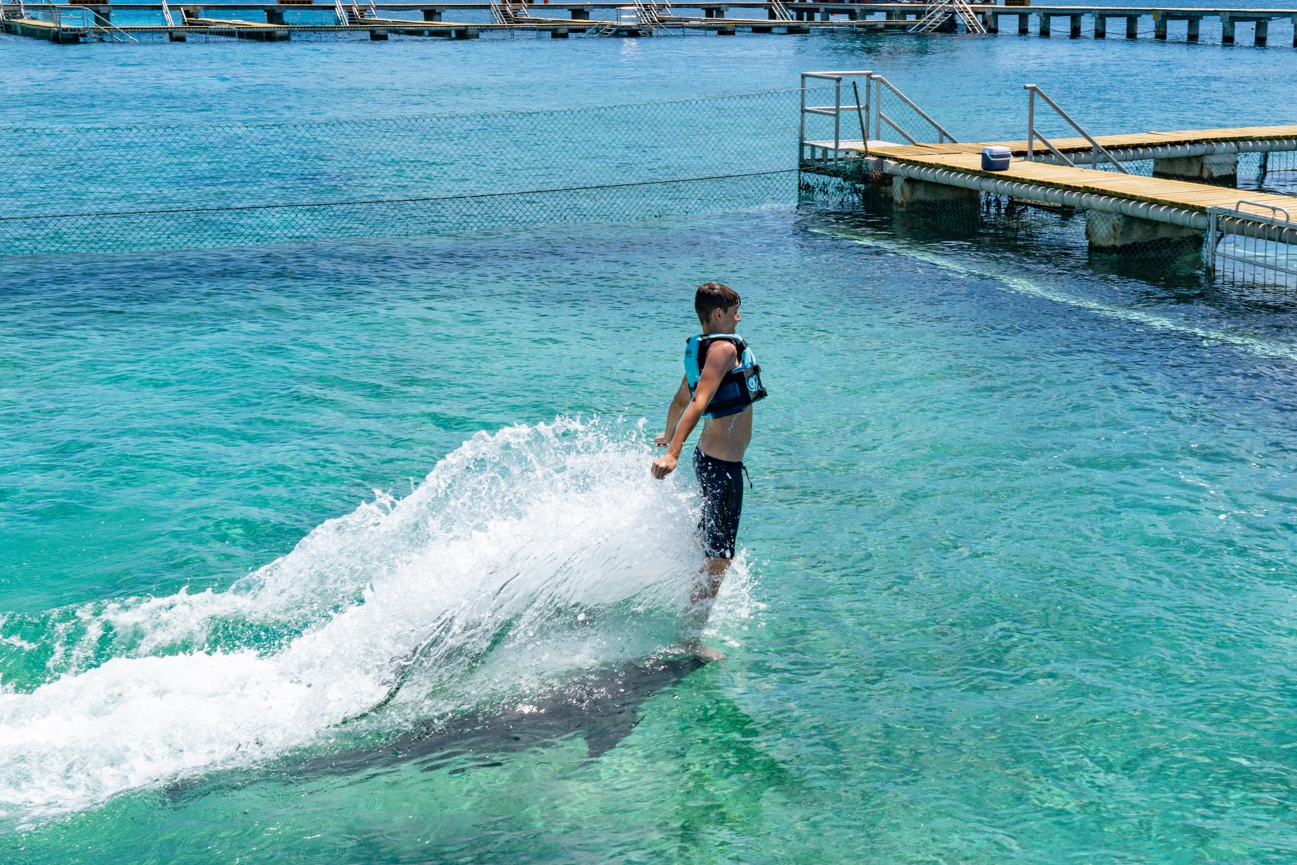 Flyboarder gliding over turquoise sea near Cozumel pier