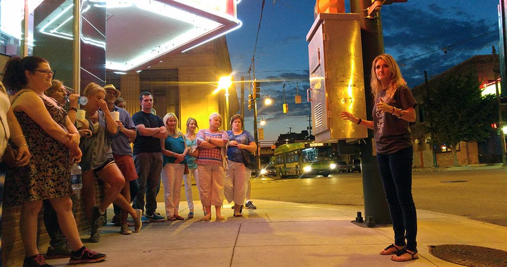 Group on guided ghost walking tour on Memphis street at night
