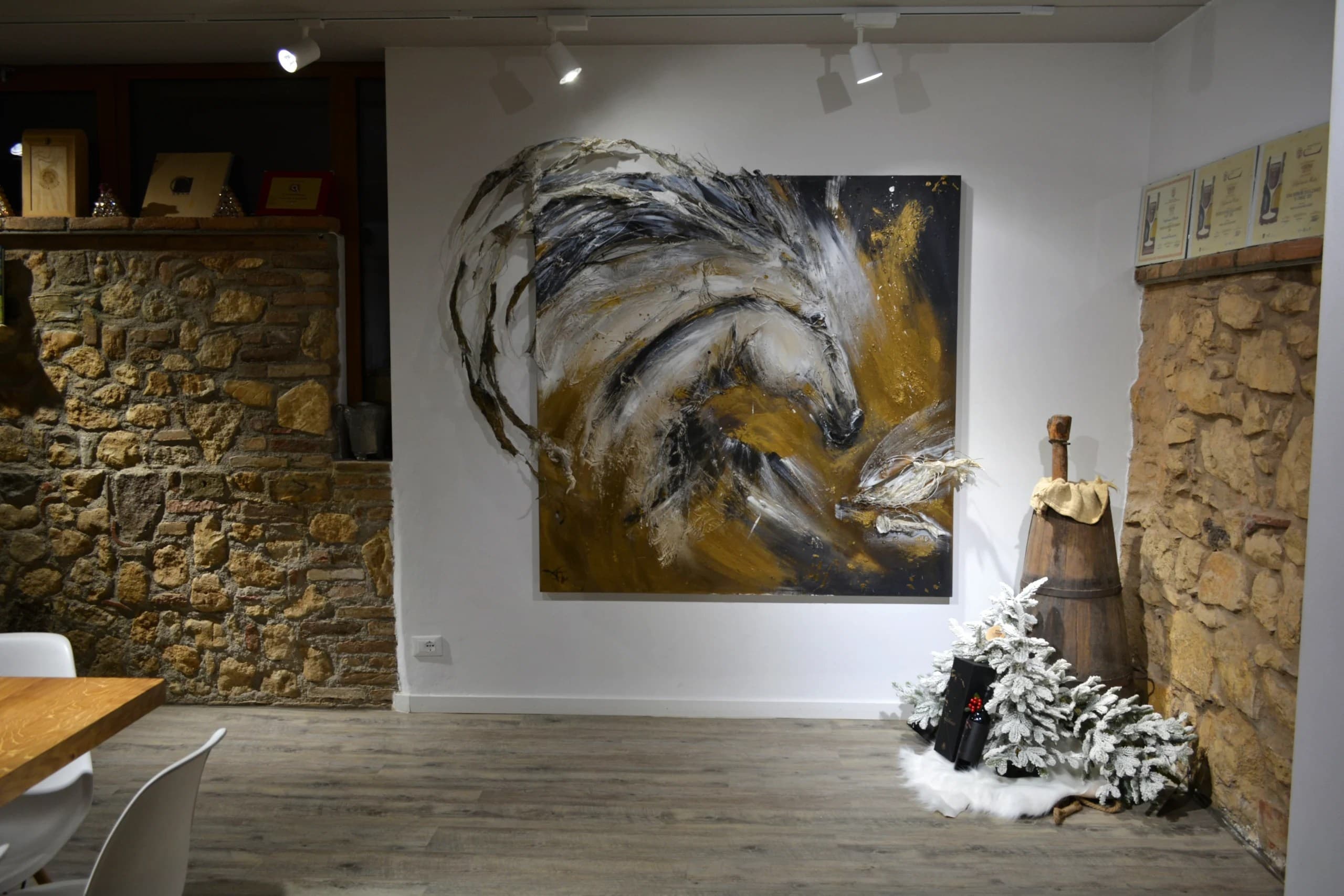 Indoor art gallery with large horse painting and wine display