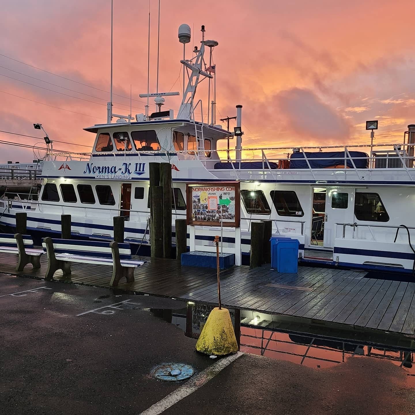 Fishing charter boat Norma-K III docked at sunset harbor
