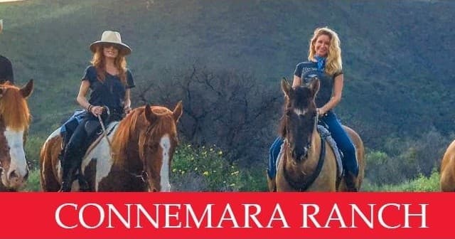 Riders horseback riding at Connemara Ranch on grassy hillside