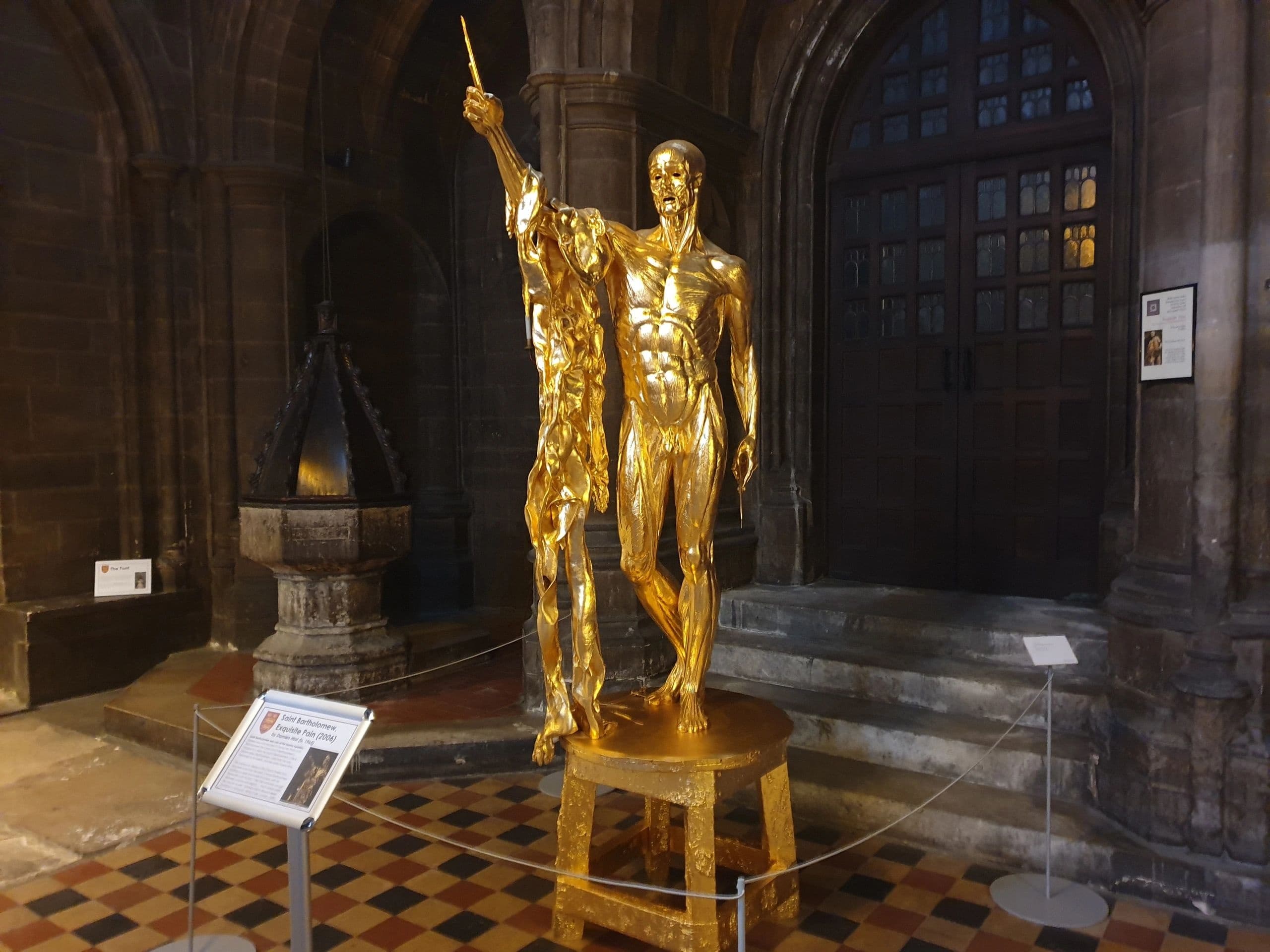 Golden statue display inside historic London cathedral museum tour