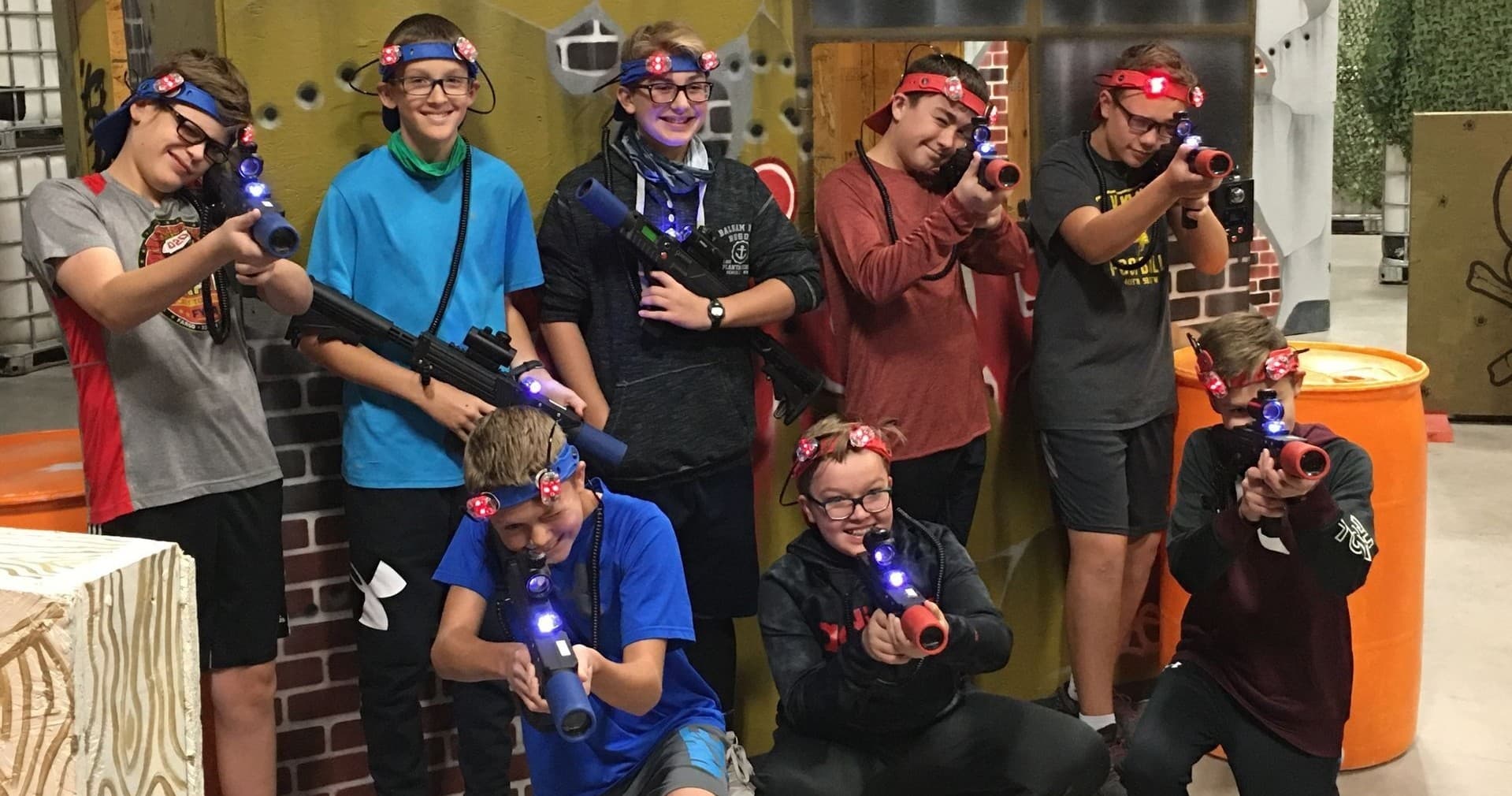 Players aiming laser guns during indoor tactical action game