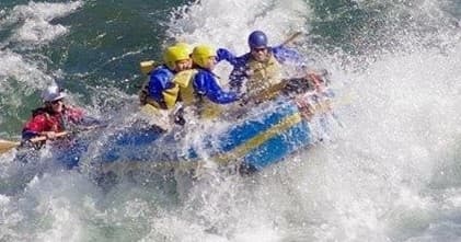 Whitewater rafters battling big waves on turbulent river run