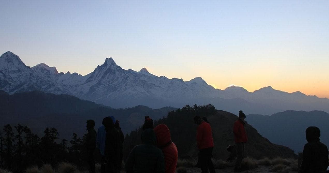 Dramatic snow-capped Himalayan peak at sunrise over valley trek