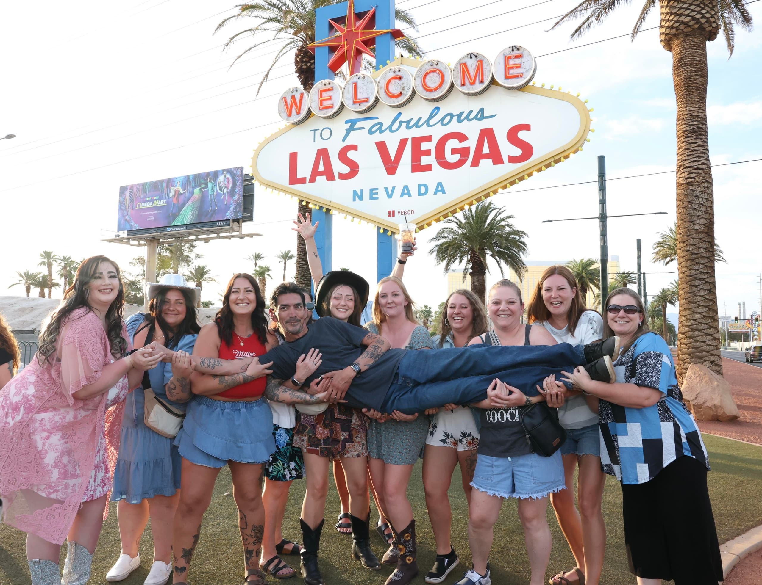 Group posing at Welcome to Fabulous Las Vegas sign, outdoor photo op