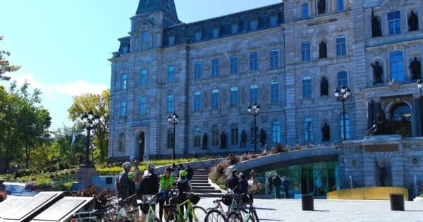 Cycling tour gathering near iconic Chateau-style waterfront hotel