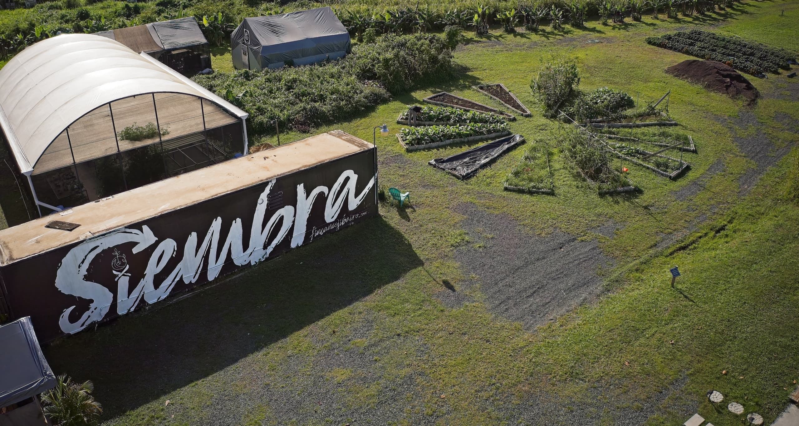 Aerial view of Siembra farm fields and greenhouse, countryside
