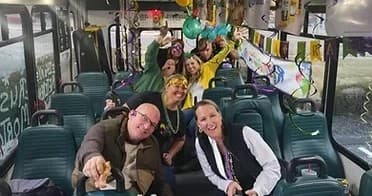 Passengers partying inside decorated party bus during group ride