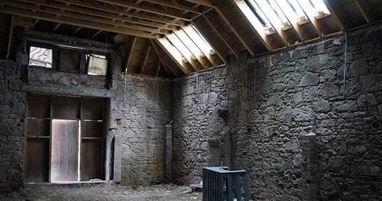 Atmospheric stone warehouse interior at distillery ruins
