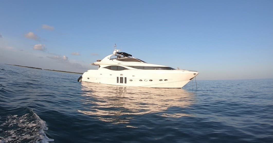 Luxury yacht cruising calm open ocean at sunset