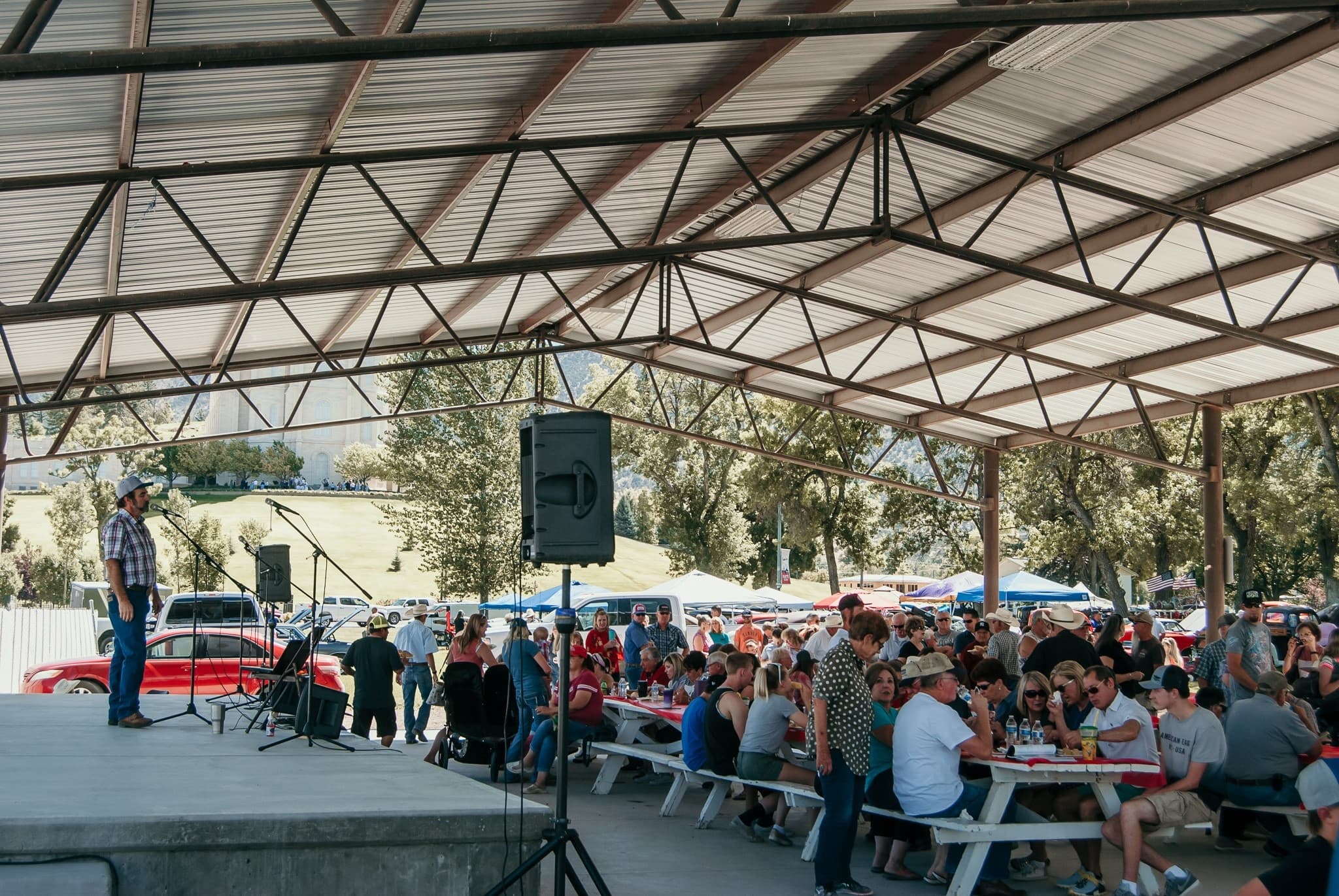 Outdoor covered pavilion with picnic crowd at fair event
