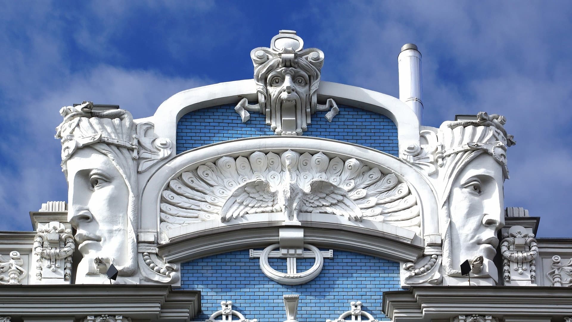 Art Nouveau building facade with sculpted faces in Riga