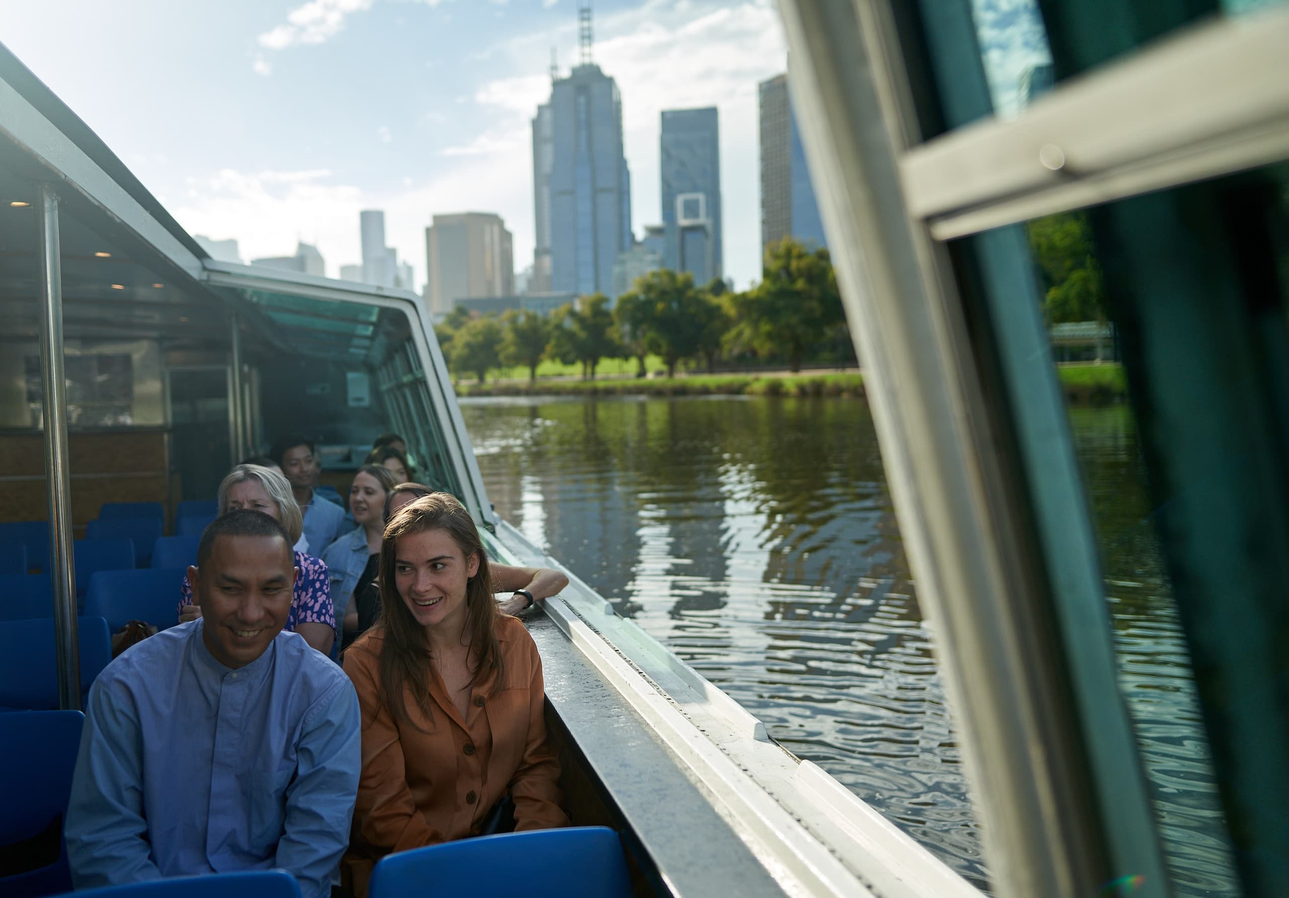 Couple enjoying Melbourne sightseeing cruise with city skyline backdrop