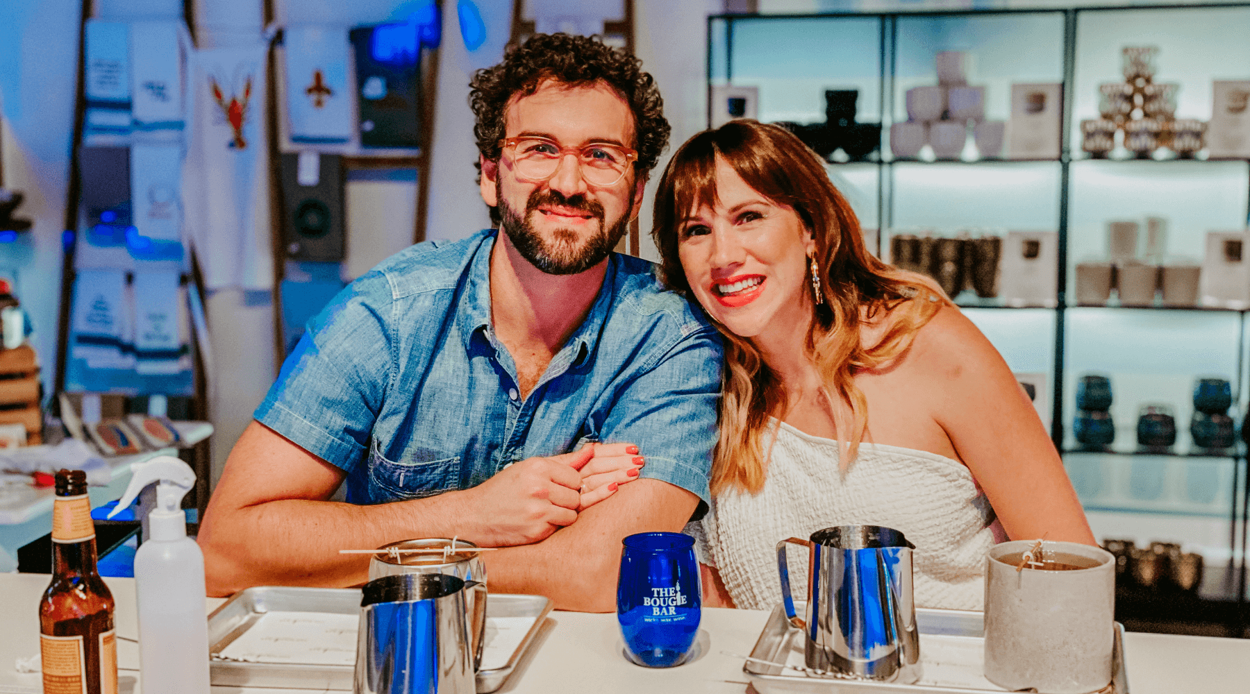 Smiling couple at candle bar workshop in retail studio
