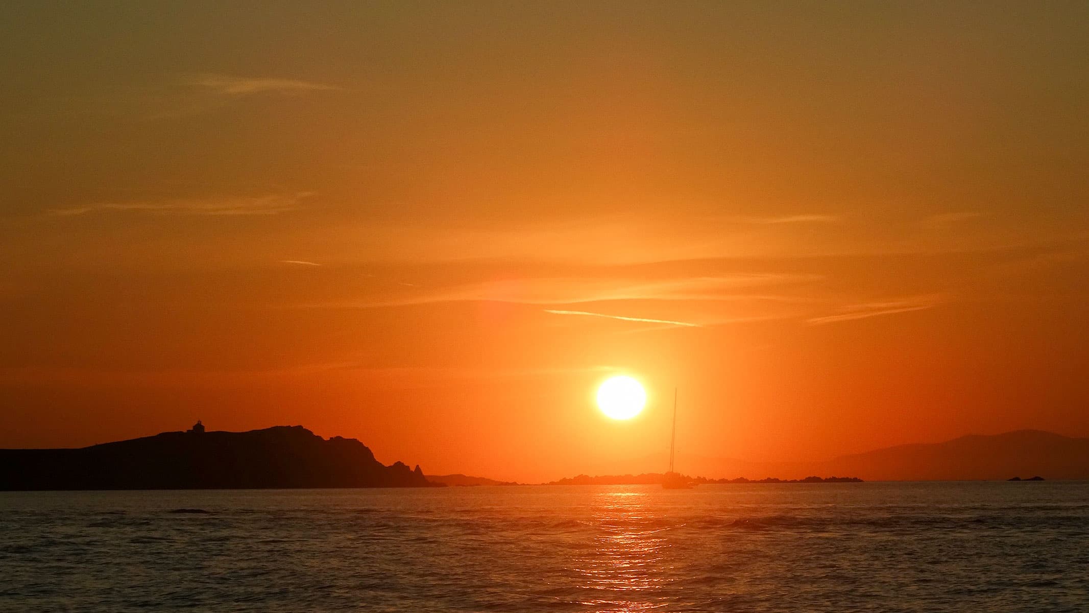Golden sunset over Aegean Sea near Mykonos, serene horizon