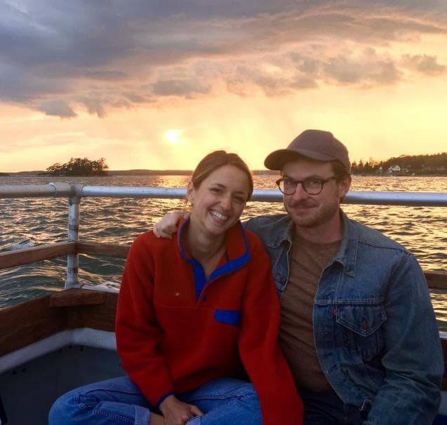 Couple enjoying sunset cruise on island waters, romantic