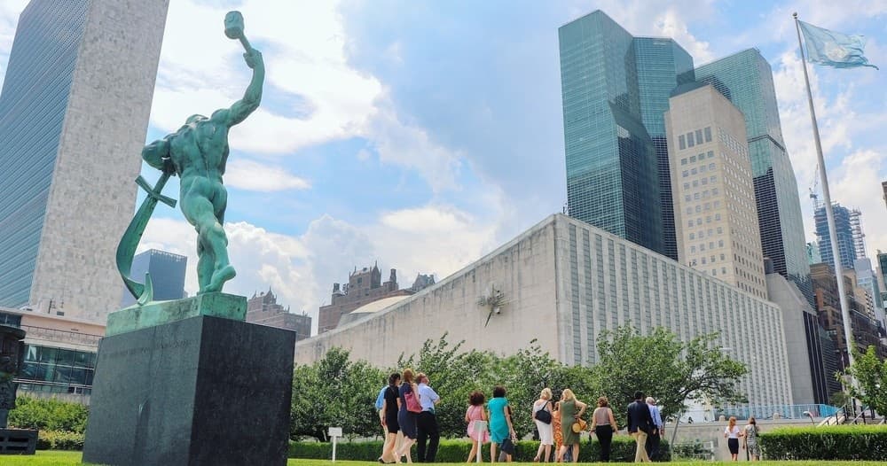 UN headquarters plaza and statue with skyline, outdoor tour