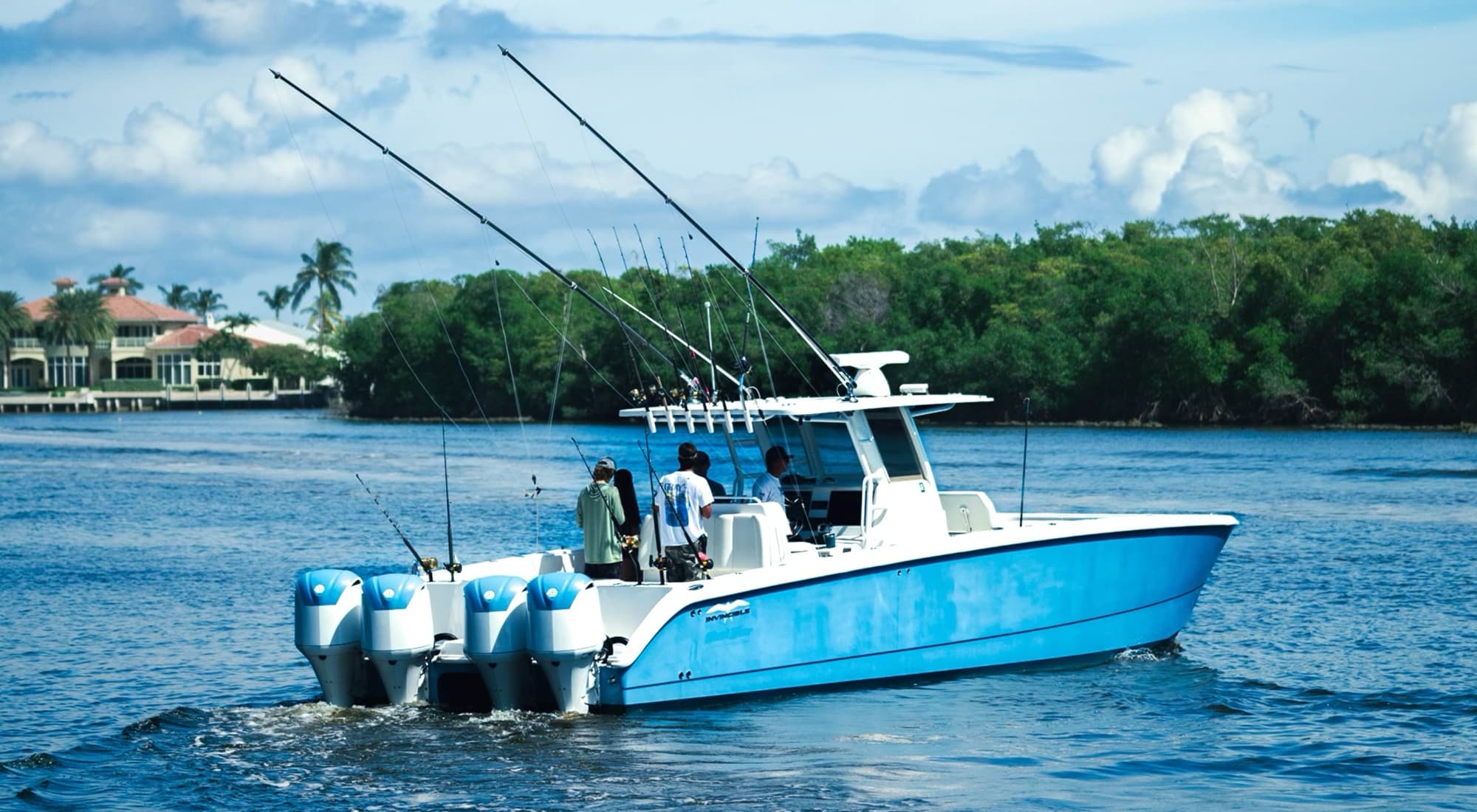 Sportfishing boat with outriggers on tropical inlet