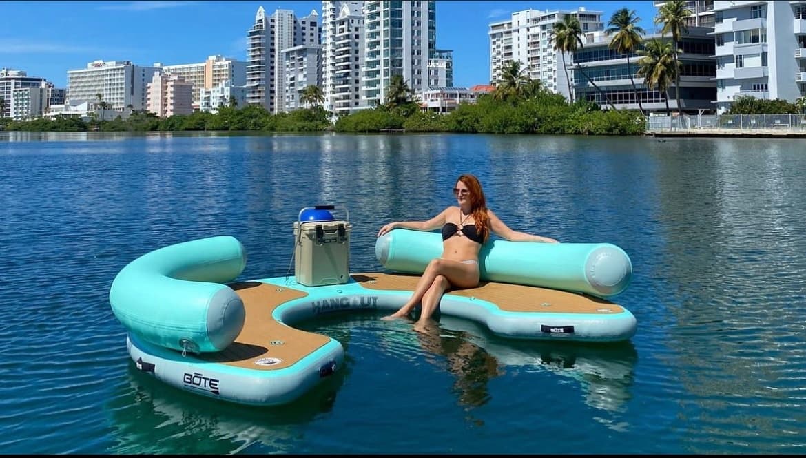 Woman lounging on inflatable float in urban lagoon