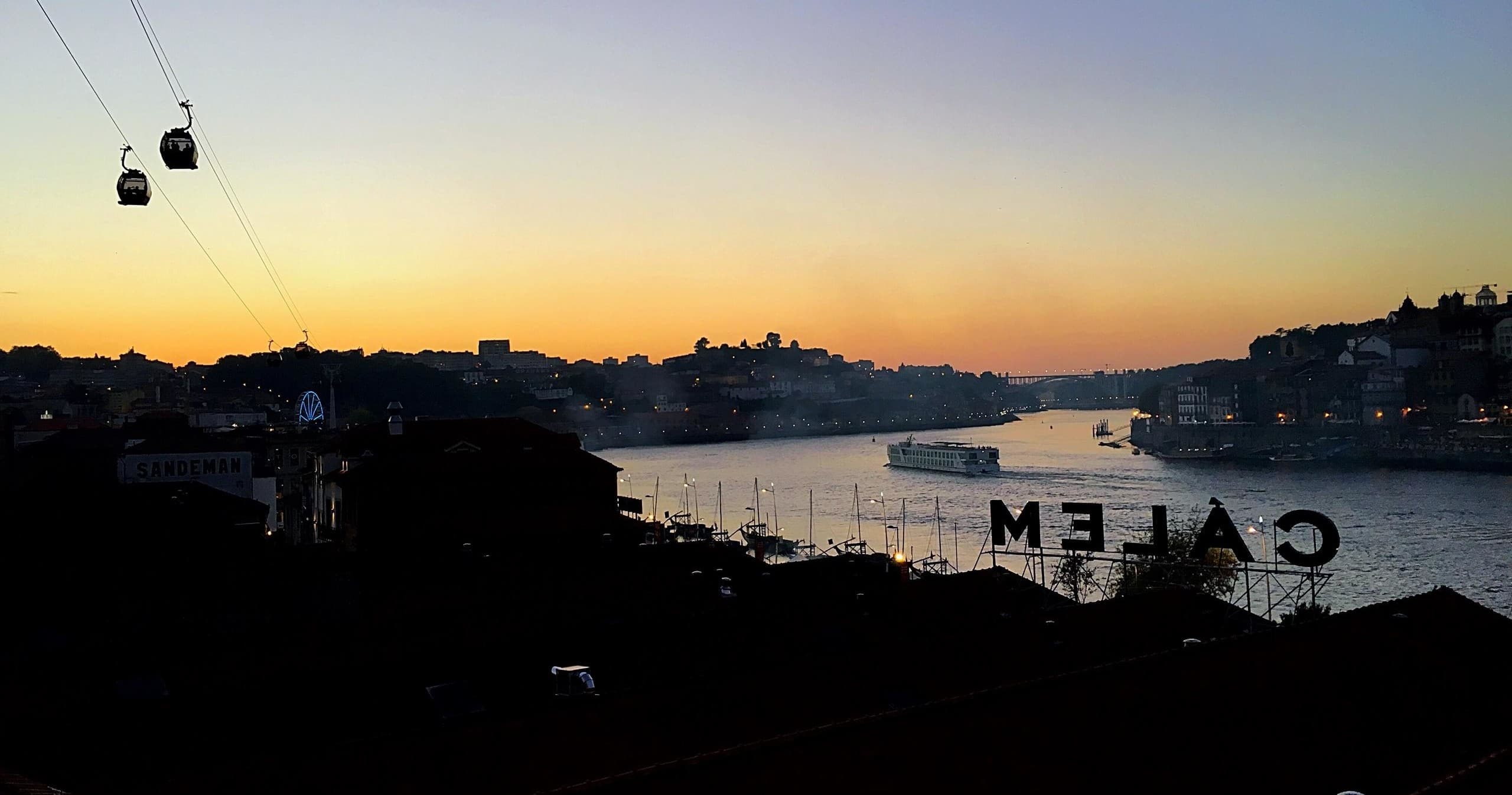 Douro River skyline at dusk with cable car silhouette in Porto
